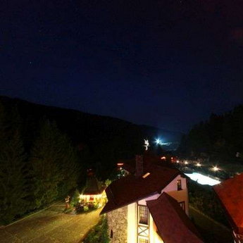 Night view of the pool and the nature of the Carpathians from the balcony of of apartments Vezha