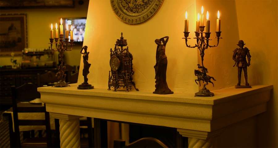 Candlesticks and figurines over the fireplace Trapezna Restaurant